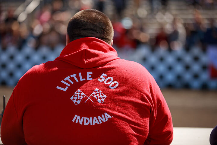 Male IU Student Foundation member watches the Little 500 race.